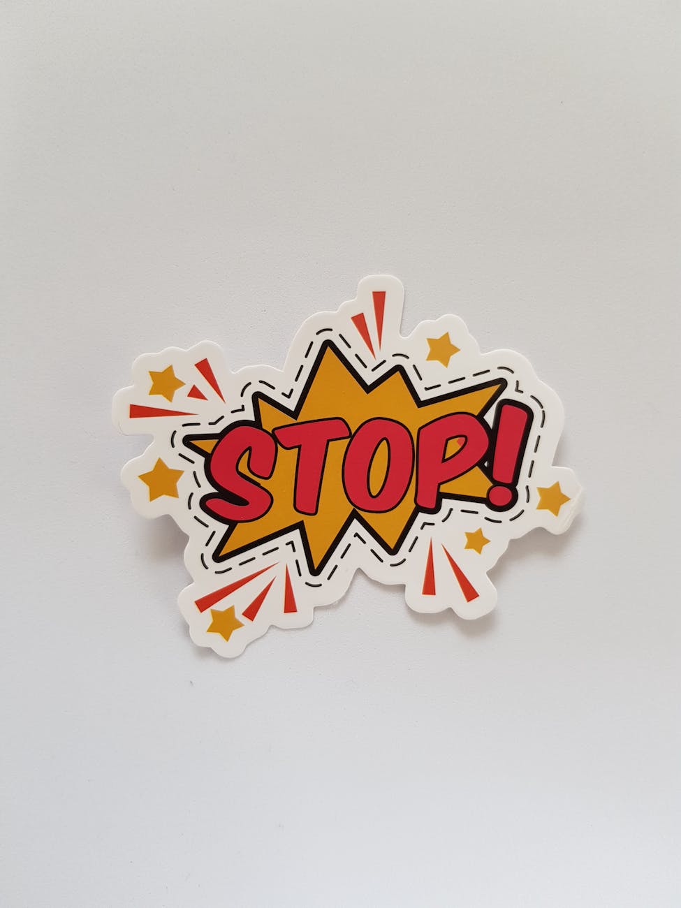 Cut out sticker in the style of Roy Liechtenstein which reads STOP 
