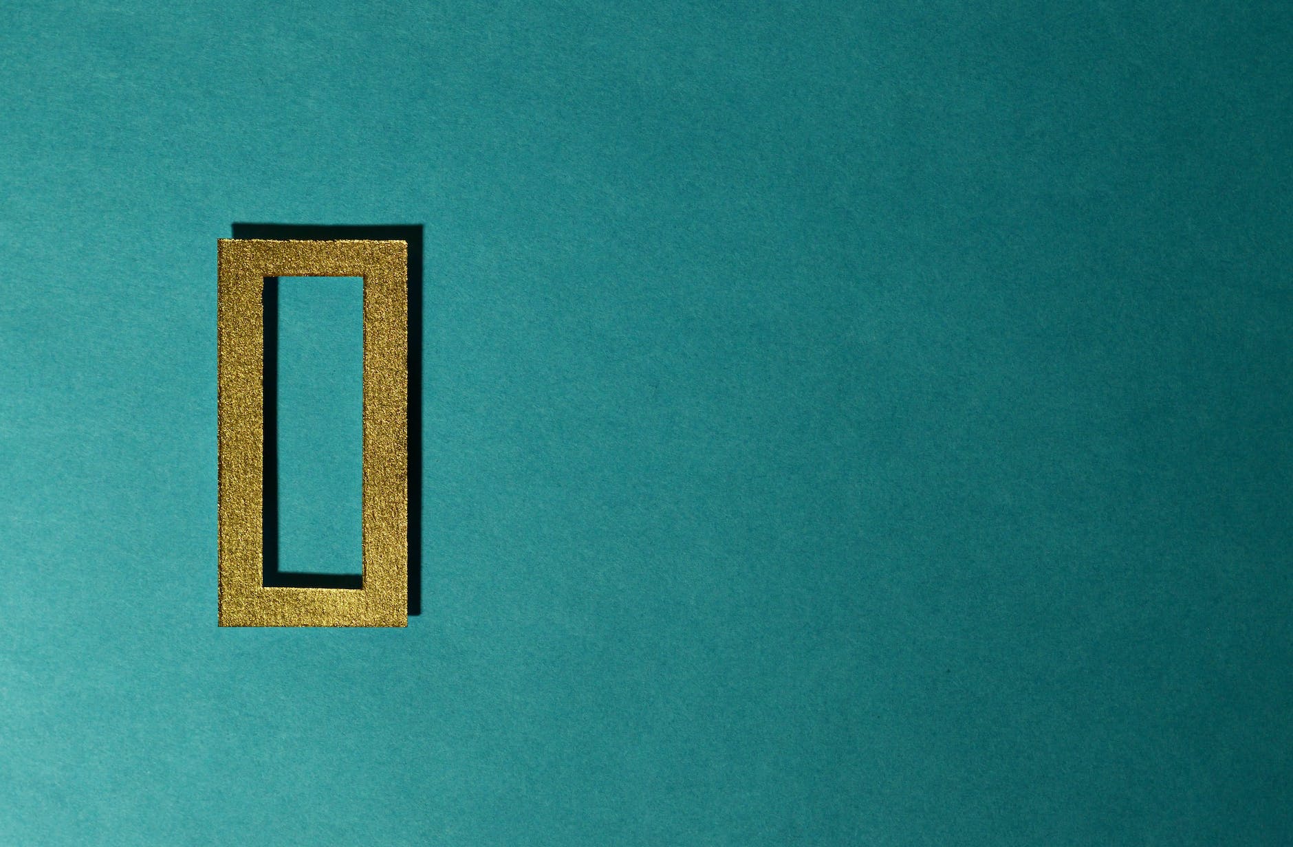 Bronze squared off zero on a turquoise background