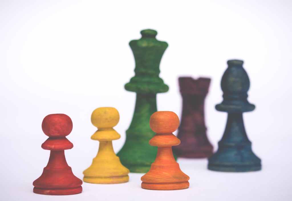Brightly coloured chess pieces

 