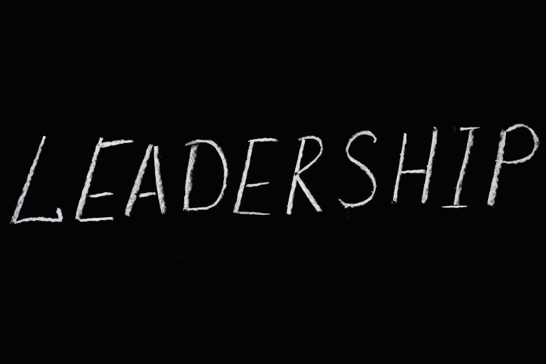 The word 'LEADERSHIP' written on a chalkboard in white chalk