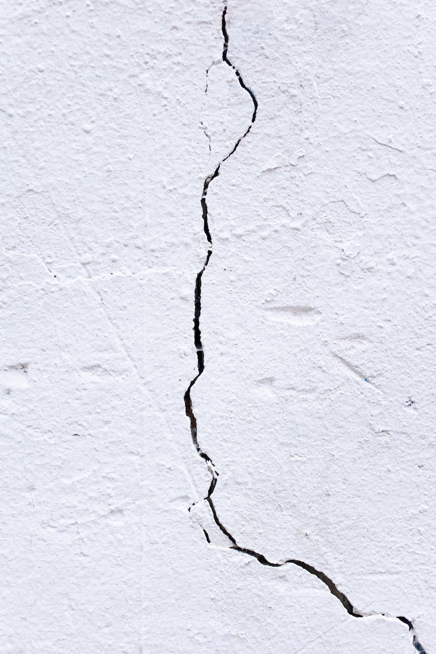 A vertical crack in a white wall