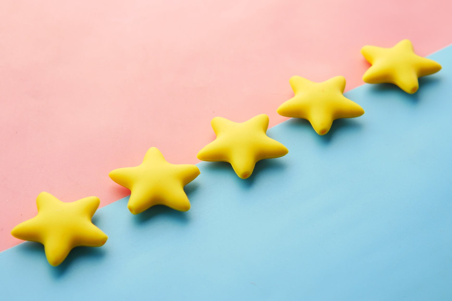 5 gold stars on a pink and blue background