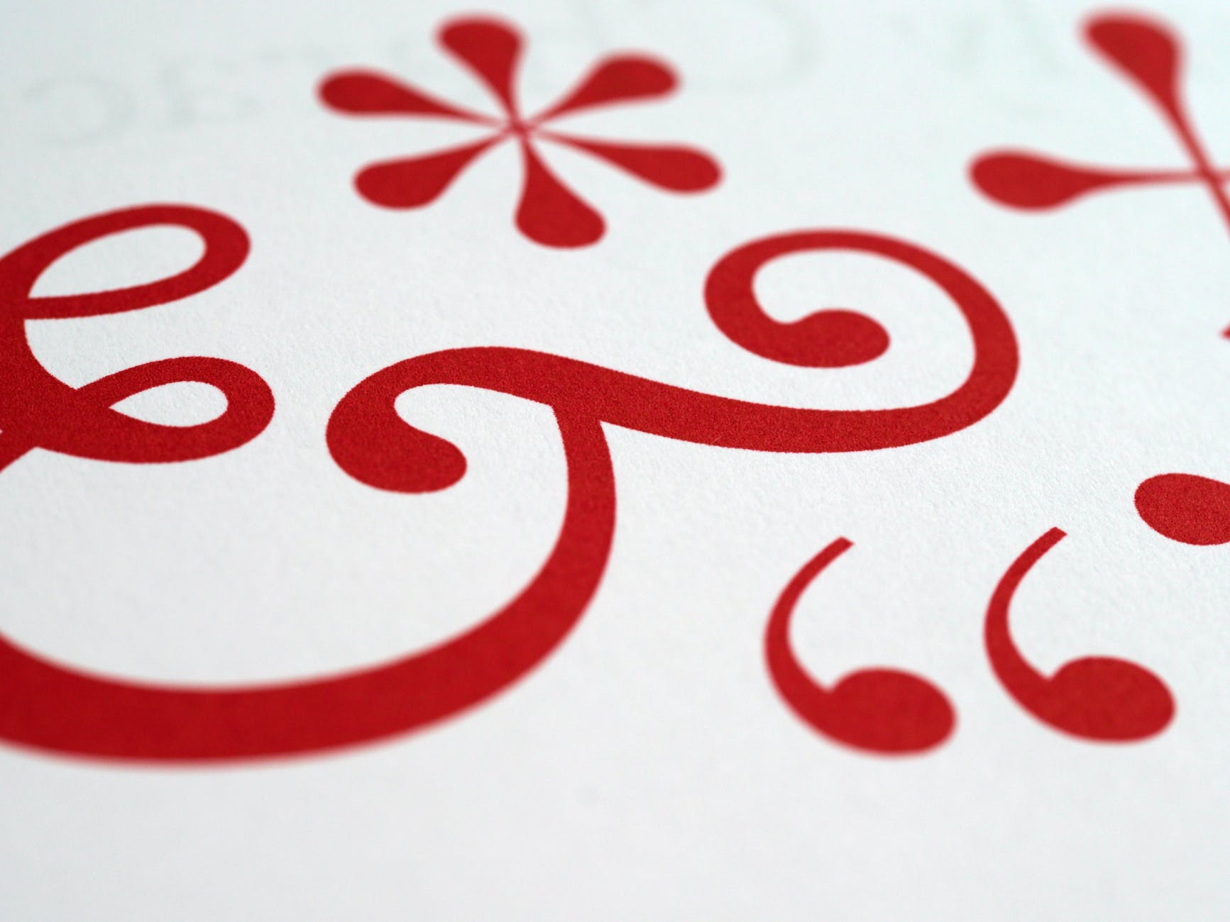 Red punctuation marks - ampersand, asterisk, etc - taken from close up on a white background