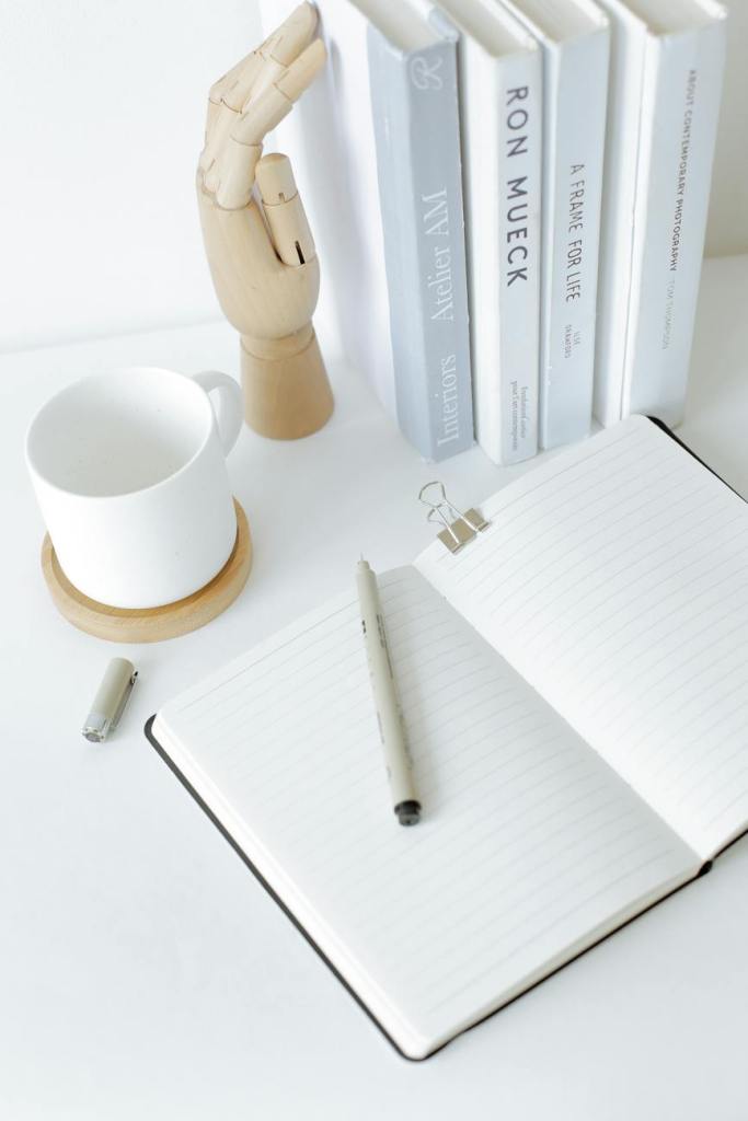 Blank open notebook on a white desk