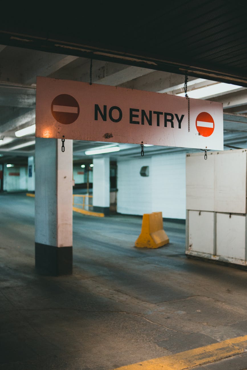 The image depicts a 'No Entry' sign in a parking garage setting.






