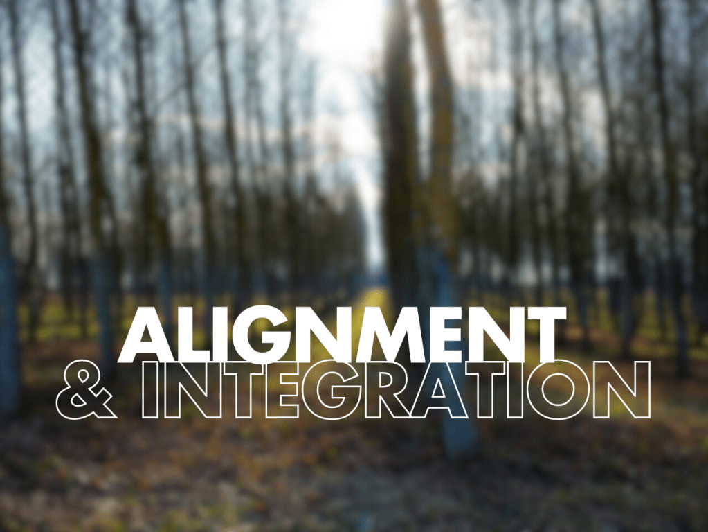 Text 'ALIGNMENT & INTEGRATION' on a blurry forest background