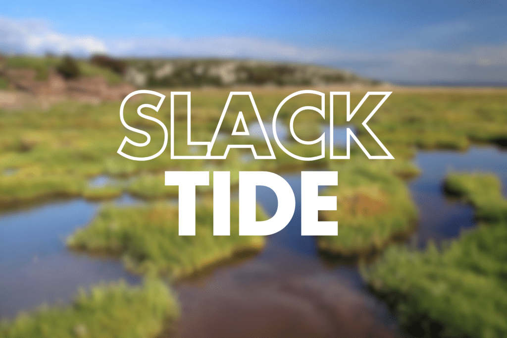 The words "SLACK TIDE" are displayed in large, bold white letters against a blurred background of a coastal landscape with a river.