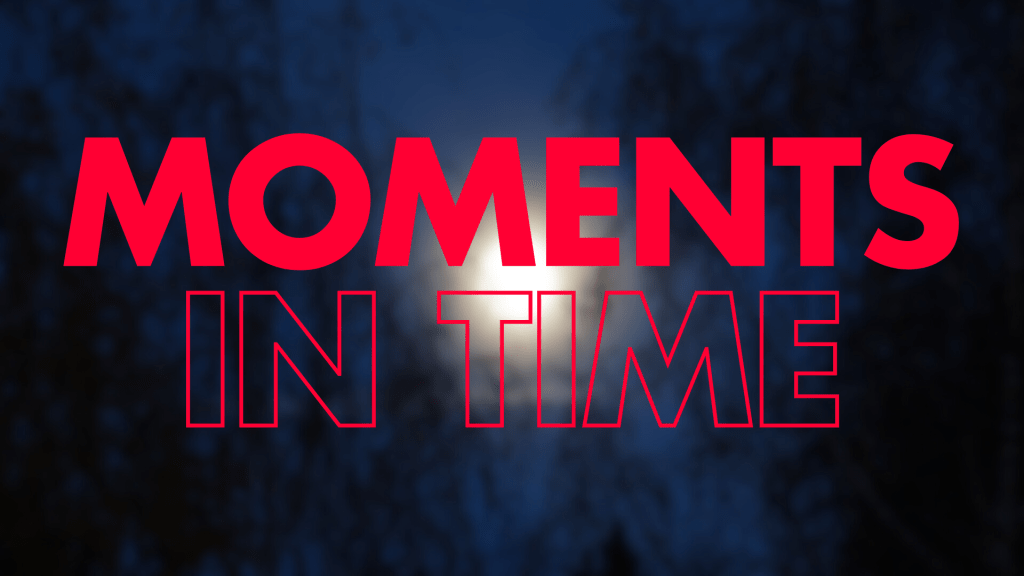 A blurred image of a moonlit scene with dark trees in the foreground, featuring the words "MOMENTS IN TIME" prominently displayed in large, bold red text.