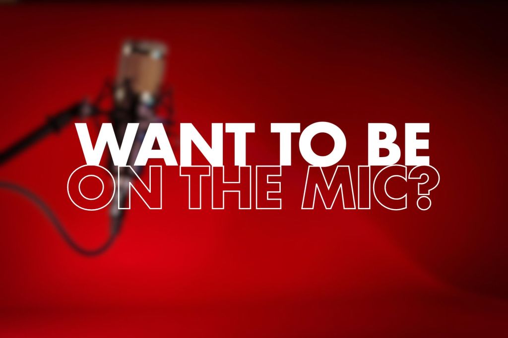 A blurred image of a microphone against a red background, featuring the words "WANT TO BE ON THE MIC?" prominently displayed in large, bold white text.

