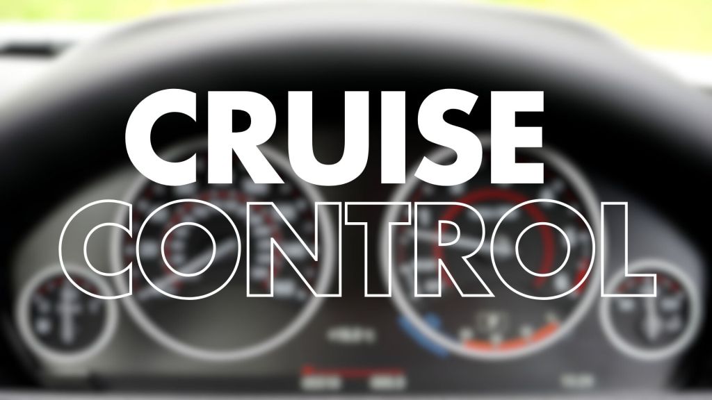 A blurred image of a car's dashboard featuring speed and engine gauges, with the words "CRUISE CONTROL" prominently displayed in large, bold white text.