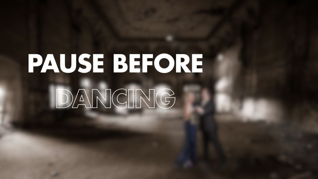 A blurred image of a couple dancing in an abandoned space, featuring the words "PAUSE BEFORE DANCING" prominently displayed in large, bold white text.