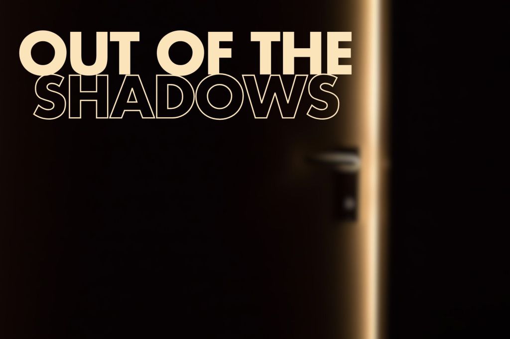 A blurred image of a partially open door with light streaming through, featuring the words "OUT OF THE SHADOWS" prominently displayed in large, bold light-colored text.

