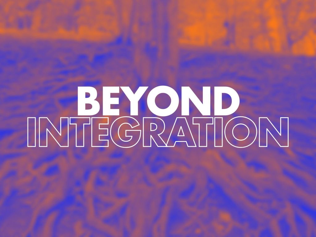 An abstract image showcasing a blurred forest scene with visible tree roots. The background features a gradient of orange and blue colours. In the foreground, bold white text reads "BEYOND INTEGRATION," creating a strong visual emphasis.