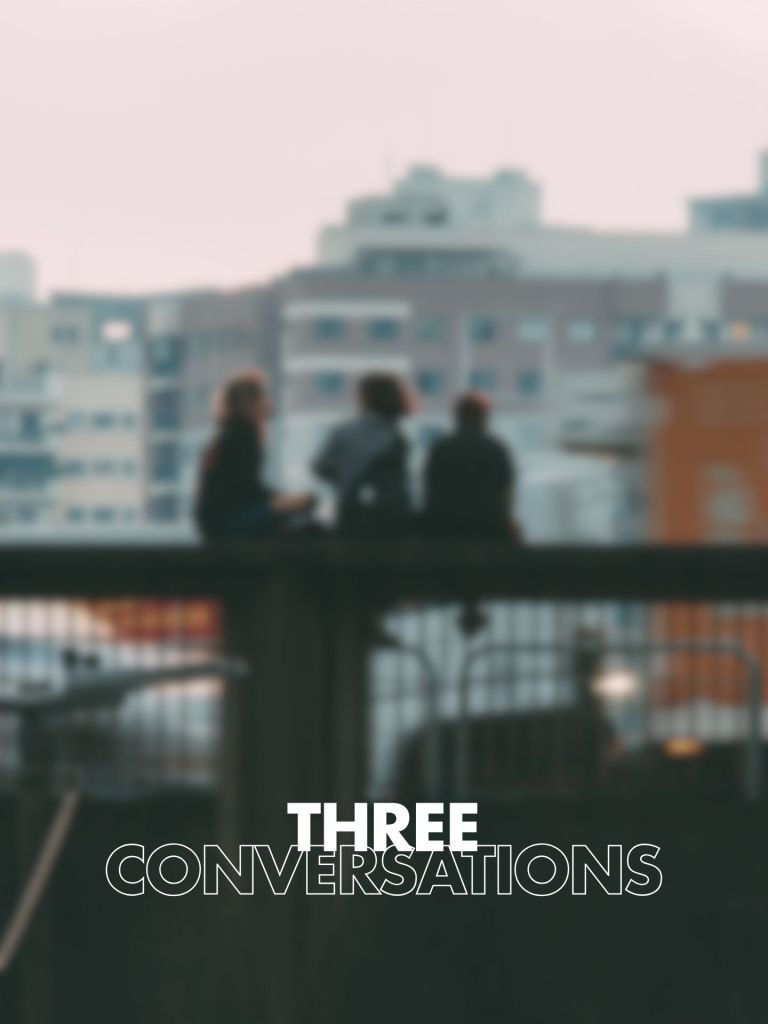 The image features a soft-focus background showing three people sitting on a ledge against a cityscape. The text "THREE CONVERSATIONS" is prominently displayed in a bold font at the bottom.
