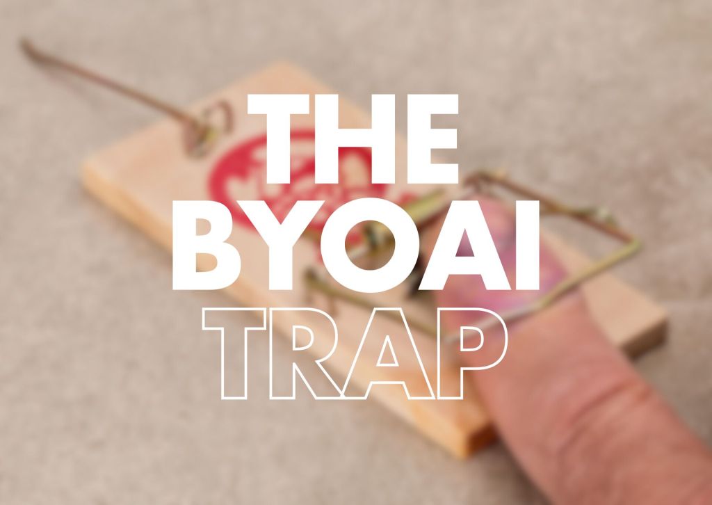 The image features a close-up of a mouse trap, with a finger positioned near the trap's mechanism. The words "THE BYOAI TRAP" are prominently displayed in large, bold, white letters across the image. The background is softly blurred, emphasizing the trap and text.