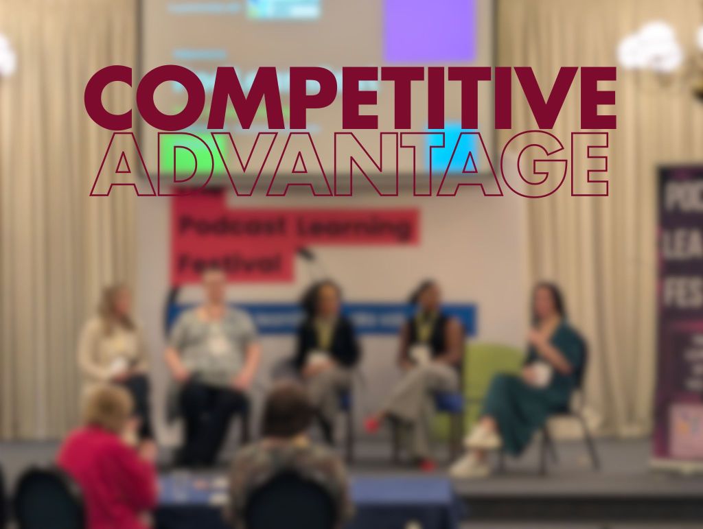 Blurry conference stage with five women panellists seated; large maroon text "COMPETITIVE" and outlined "ADVANTAGE" are overlaid at top centre.

