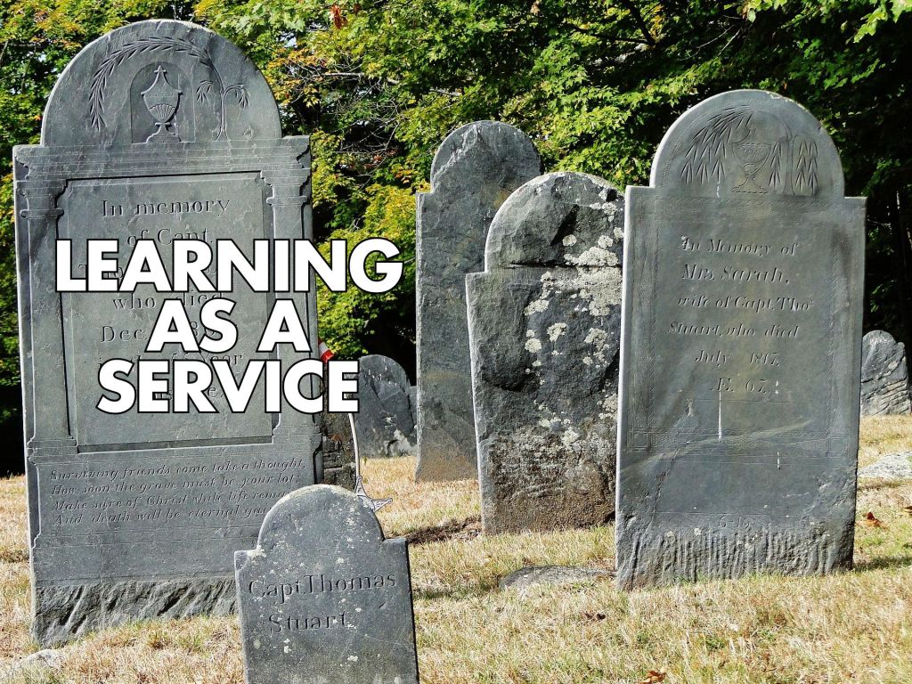White text reading “LEARNING AS A SERVICE” over a photo of old gravestones in a cemetery with trees in the background.